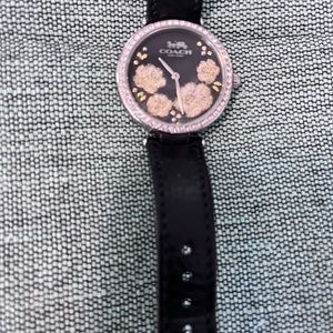 Coach watch with crystal bezel, flowers, and black leather band